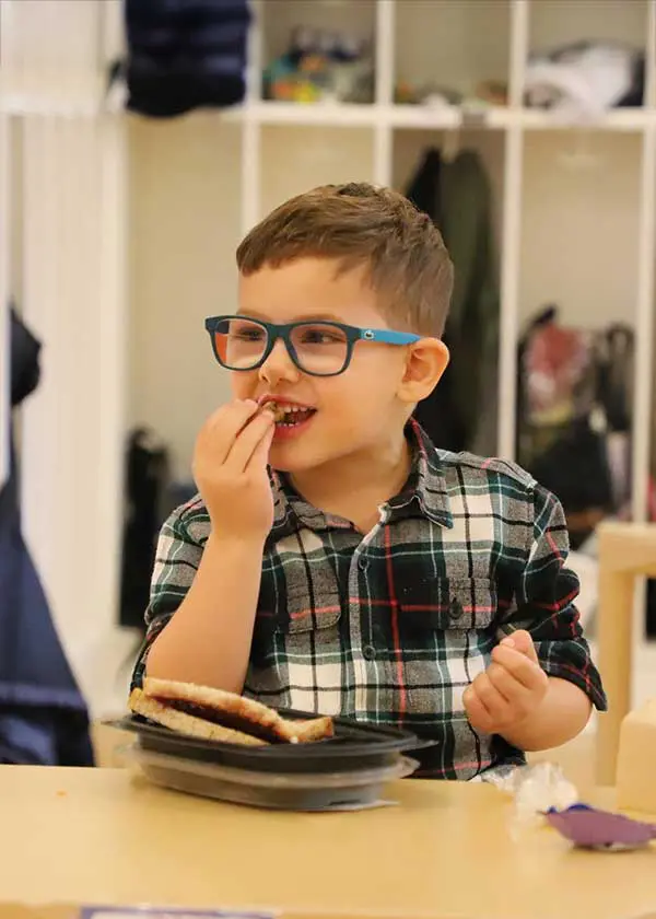 Child eating lunch at table